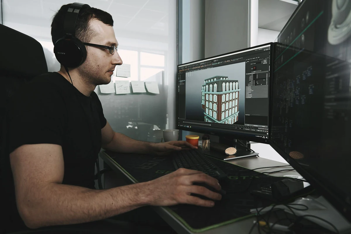 designer 3D rendering a house on their computer